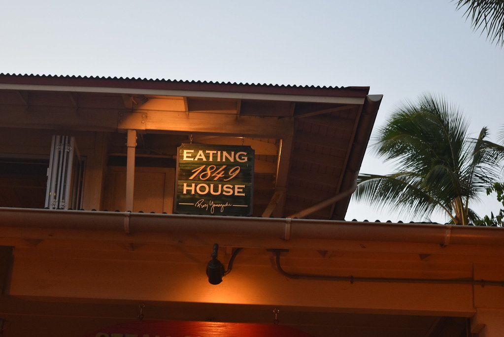 The lit Eating House 1849 sign under the restaurant's eaves