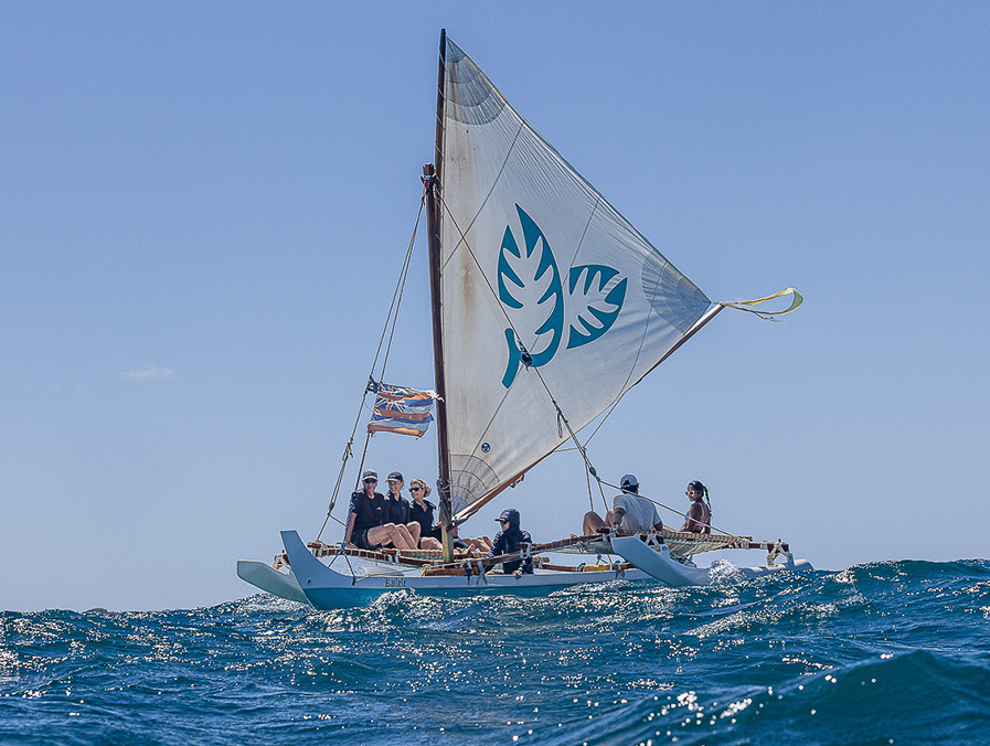 A traditional Hawaiian sailing canoe under sail off Kaua'i's south shore
